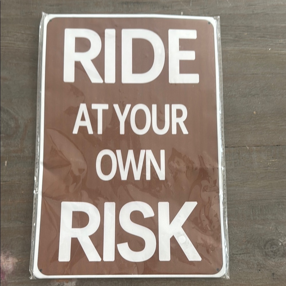 Brown 'Ride at Your Own Risk' Sign